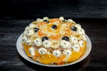 biscuit cake with fruit photographed on a dark background 