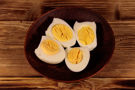 Boiled eggs on a plate on wooden table