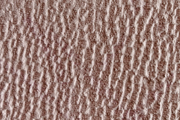 pale pink plaster wall pattern closeup