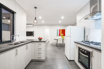 Kitchen and dining area in modern Australian home with colourful decor.