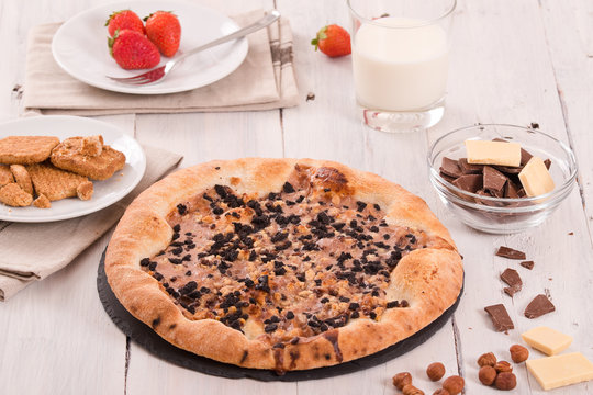 Sweet chocolate pizza with cookies. 
