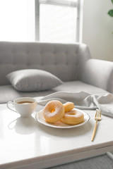Classic donut. Morning breakfast on table in living room at home.