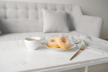 Classic donut. Morning breakfast on table in living room at home.