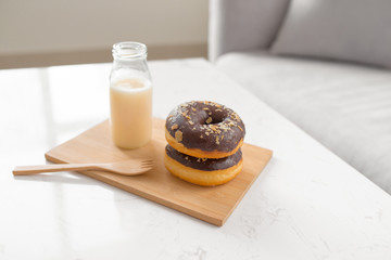 Classic donut. Morning breakfast on table in living room at home.