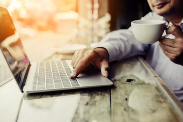 Fototapeta premium businessman use smartphone and laptop on wwoden desk business ideas concept