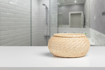 Straw decorative basket on a white desk front view