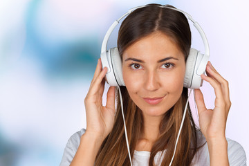 Portrait of a beautiful woman student  listening to music