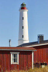 Red wooden houses lighthouse, Hailuoto island. Marjaniemi beach. Finland © h368k742