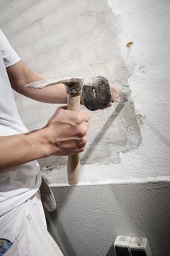 Bricklayer and his bricklayer&acute;s assistant working at a house
