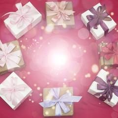 Festive background with gift boxes on pink background.