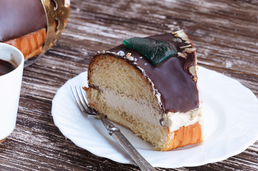 Original Roscon de reyes, chocolate desert eaten  in Spain for celebrate Epiphany or Dia de Reyes Magos, Three Wise Men Day. Spanish Christmas with traditional crown on wooden background.