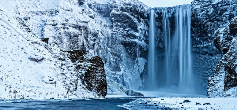 Beautiful panoramic photo of Skogafoss waterfall in winter, Iceland