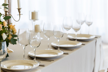 plates, glasses, candles, serving at the table