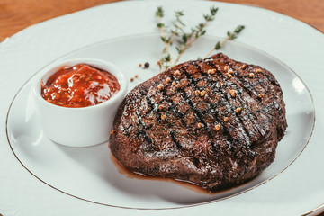 deep fried steak laying on plate with sauce