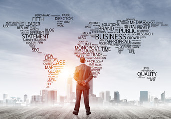 Motivation and inspiration concept with modern cityscape and businessman observing it