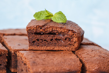 Pieces of dark chocolate brownie on slate board. Brownie is one type of chocolate cake.