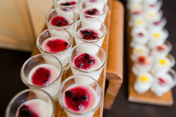 Glass shots  pastry. wedding catering food. mini canapes food.  tasty dessert. Beautiful decorate catering banquet table.  snacks and appetizers. wedding celebration
