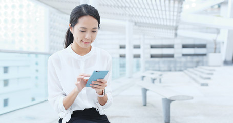 Business woman work on cellphone in outdoor