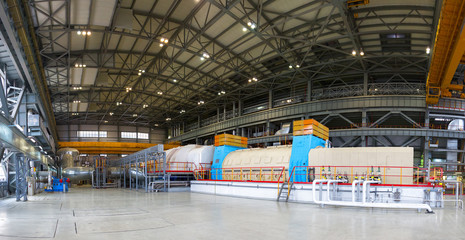 Powerful steam turbine in the turbine hall of the nuclear power plant