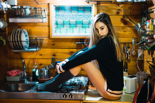 Provocative woman posing on kitchen counter