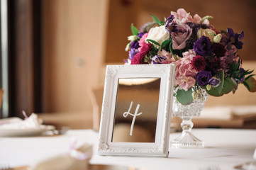 Wedding table with flowers and sign number