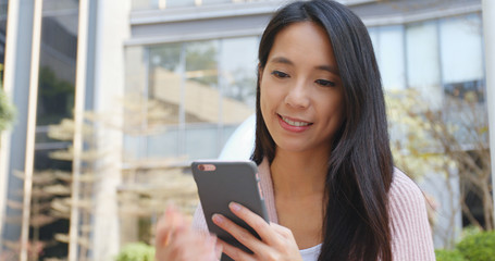 Woman use of smart phone outside shopping mall