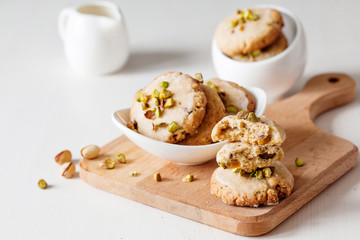 Butter cookies with pistachios on wooden board