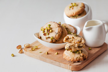 Butter cookies with pistachios on wooden board