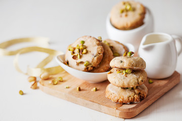 Butter cookies with pistachios on wooden board
