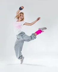 Foto auf Leinwand Young beautiful slim girl dancing on a white studio background © Aikis