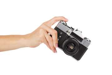 Fototapeta premium Hand holds an old photo camera, isolated