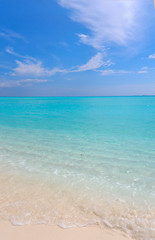 Peaceful white sandy beach with blue ocean lagoon