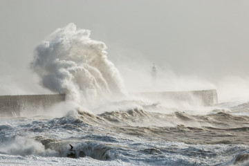 Newhaven, Sussex, Stormy Seas With Wave Crashing against Sea Wall.  Lighthouse Partially Visible...