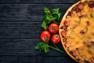Homemade pizza on a wooden background. Top view. Copy space.