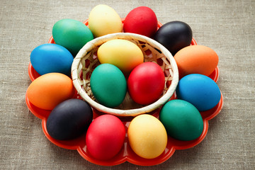 Easter concept painted eggs on cloth in plate for holiday with place for text pattern with frame