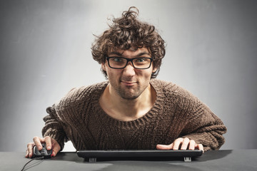 Young man playing game on a computer.