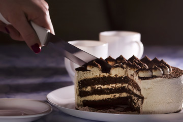 Chocolate Cake with Cream and Two  White Cups of Coffee .