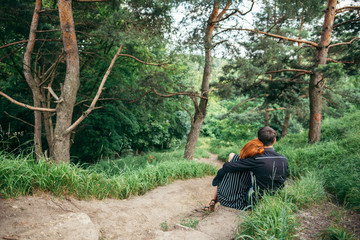Fototapeta premium couple resting on trail and hugging each other