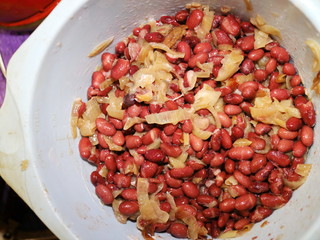 cooking a lobio red bean and onions in a blue bowl