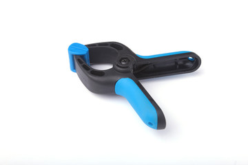 Obraz premium Black plastic spring clamp isolated on white background.