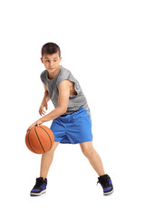 Fototapeta premium Boy dribbling with a basketball