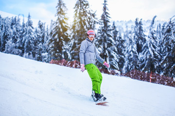 Fototapeta na wymiar woman snowboarder skiing in the mountains