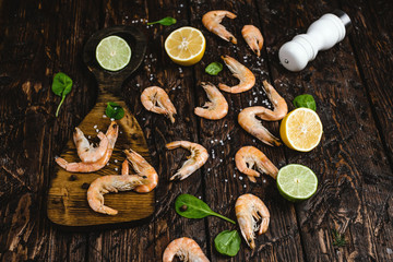 close-up view of delicious shrimp with citrus fruits and spices on rustic wooden table