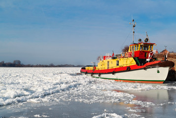 Wisla view with boat on ice.