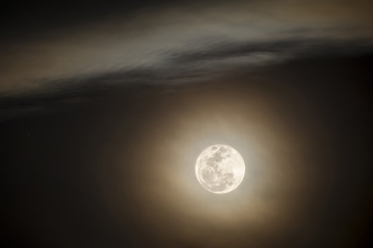Close up of full moon on dark sky background.