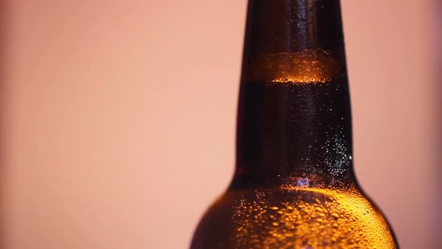 Brown botte of beer with water drop.