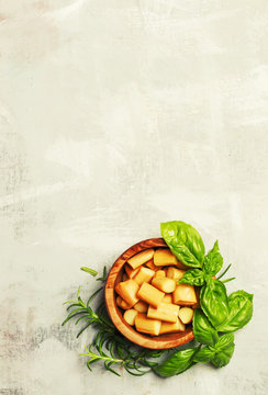 Traditional Caucasian smoked Chechel cheese with spicy herbs, food background, top view