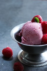 Homemade Raspberry ice cream topped with fresh berries, selective focus