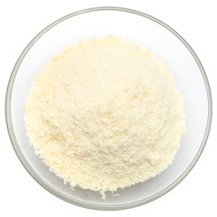 grated Parmesan cheese in glass bowl on white background