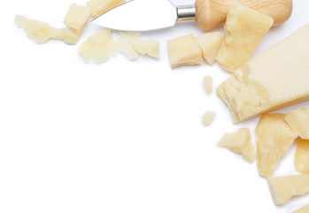 pieces of Parmesan cheese and knife on white background